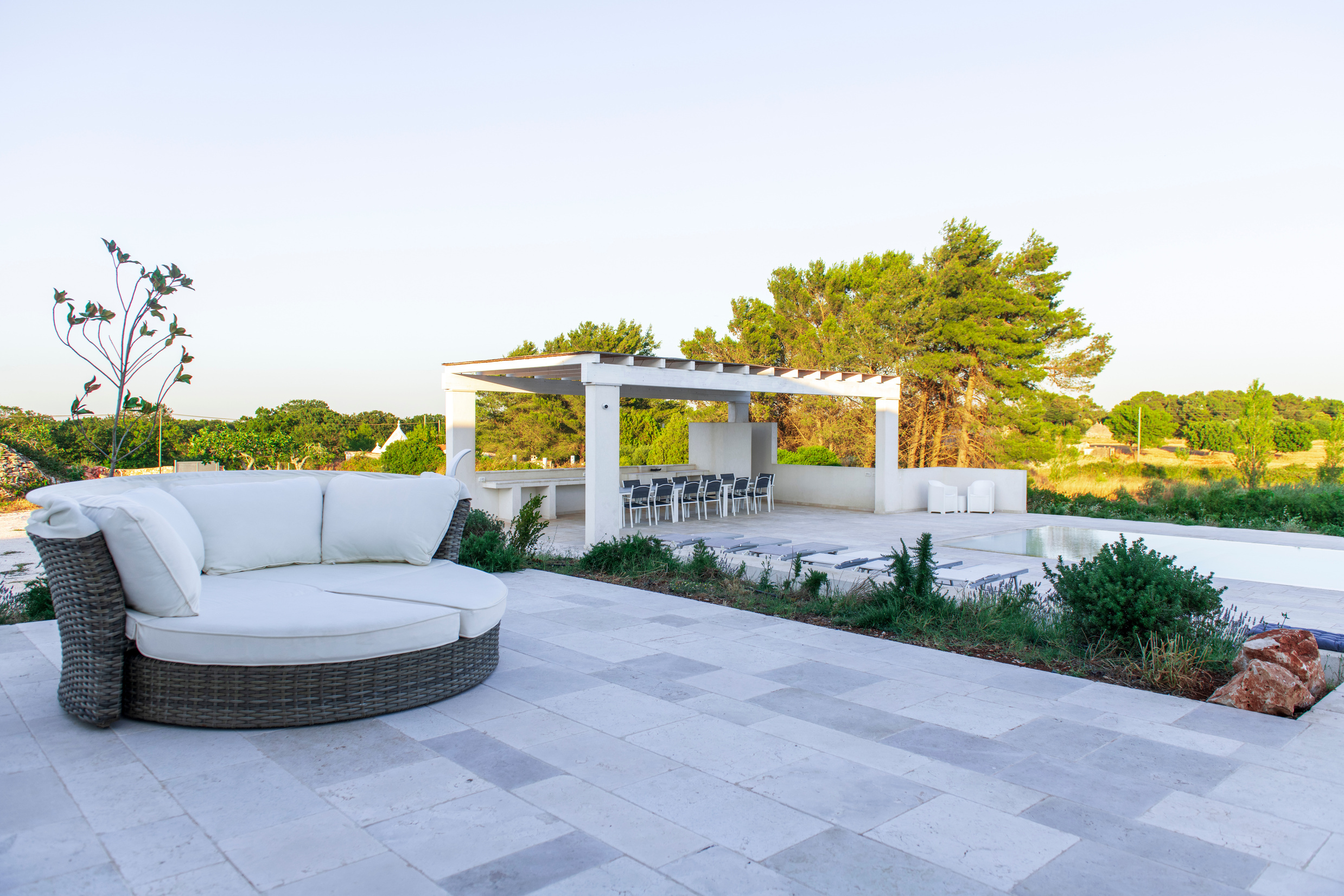 Patio with white daybed and pool, Residenza del Duca